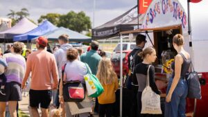 Many people at an outdoor event at Caulfield Race Course